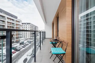 a balcony with a view of a city at Tauron Arena Premium Apartment with Underground & Outdoor Parking by Renters Prestige in Kraków