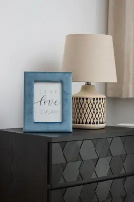 a table with a lamp and a picture on it at Tauron Arena Premium Apartment with Underground & Outdoor Parking by Renters Prestige in Kraków