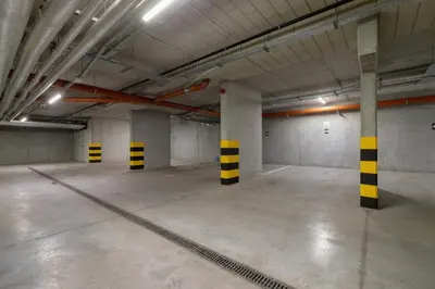 an empty parking garage with yellow and black columns at Tauron Arena Premium Apartment with Underground & Outdoor Parking by Renters Prestige in Kraków