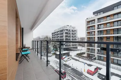 an apartment balcony with a view of a city at Tauron Arena Premium Apartment with Underground & Outdoor Parking by Renters Prestige in Kraków