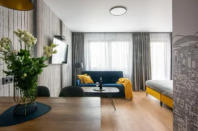 a hotel room with a bed and a couch at InPoint Kazimierz&Old Town Apartments- Free Underground Parking in Kraków