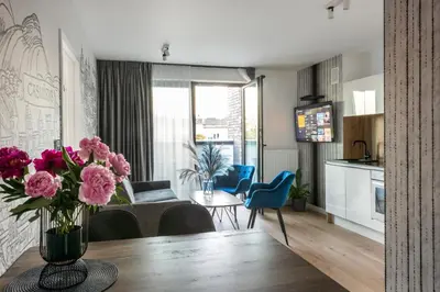 a living room with a blue couch and a table at InPoint Kazimierz&Old Town Apartments- Free Underground Parking in Kraków