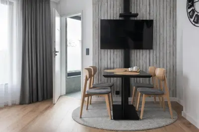 a hotel room with a bed and a couch at InPoint Kazimierz&Old Town Apartments- Free Underground Parking in Kraków
