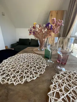 a table with wine glasses and flowers on it at Domek z Widokiem Na Bliżniaki in Chocznia