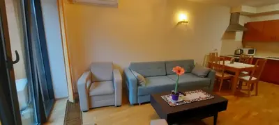 a living room with a couch and a table at Angel City Apartments in Kraków