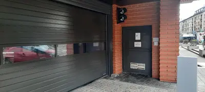 a black door on a brick building at Angel City Apartments in Kraków