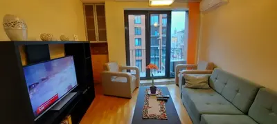 a living room with a couch and a flat screen tv at Angel City Apartments in Kraków