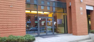 a glass building with a car inside of it at Angel City Apartments in Kraków