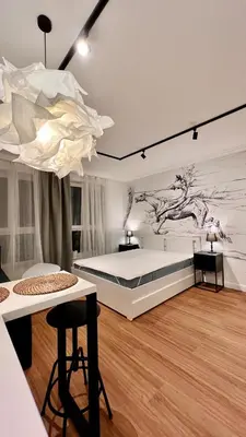 a bedroom with a bed with a painting on the wall at Way2Stay Centrum in Kraków