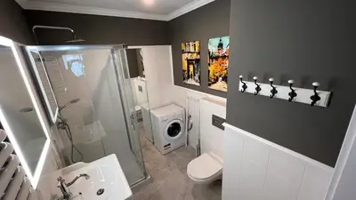 a bathroom with a shower toilet and a sink at Way2Stay Centrum in Kraków