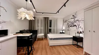 a bedroom with a bed and a desk and a kitchen at Way2Stay Centrum in Kraków