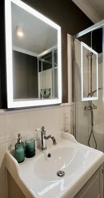 a bathroom sink with two green candles on it at Way2Stay Centrum in Kraków
