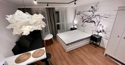 a small room with a bed and two tables at Way2Stay Centrum in Kraków