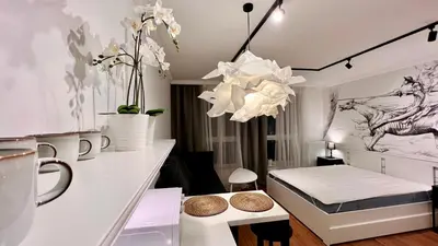 a bedroom with a bed and a table with flowers at Way2Stay Centrum in Kraków