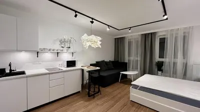 a kitchen and living room with a bed in a room at Way2Stay Centrum in Kraków