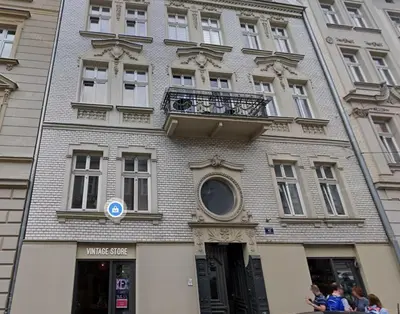 a building with a balcony on the side of it at Starowiślna 43 (C) by Homeprime in Kraków