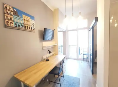a room with a desk and a tv on a wall at Starowiślna 43 (C) by Homeprime in Kraków