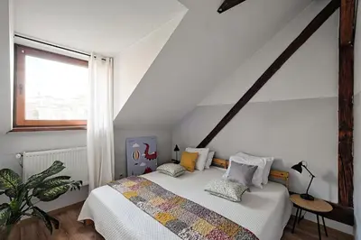 a bedroom with a bed with pillows on it at Urban Nest Apartments Augustiańska 4 in Kraków