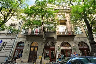 a building with a car parked in front of it at Urban Nest Apartments Augustiańska 4 in Kraków
