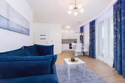 a living room with a couch and a table at Wiślane Tarasy Lux Apartments Cracow by Renters Prestige in Kraków