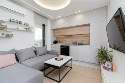 a white bathroom with a sink and a mirror at Wiślane Tarasy Lux Apartments Cracow by Renters Prestige in Kraków