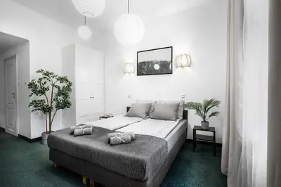 a bedroom with a large bed with two pillows on it at 27Rooms Czapskich Great Location, Old Town in Kraków