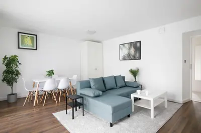a living room with a blue couch and a table at 27Rooms Czapskich Great Location, Old Town in Kraków