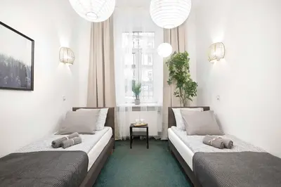 a room with two beds with pillows on them at 27Rooms Czapskich Great Location, Old Town in Kraków