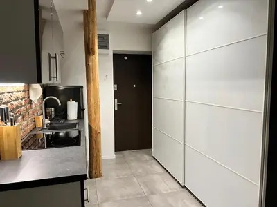 a living room with a couch and a mirror at Apartament Bronowice in Kraków