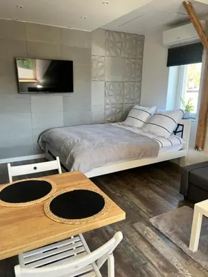 a kitchen with a counter and a brick wall at Apartament Bronowice in Kraków