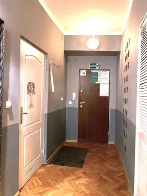 a hallway with a door leading to a room at REAL Hostel in Kraków