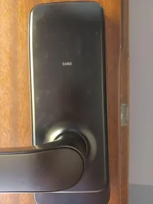a close up of a door with a cell phone at REAL Hostel in Kraków