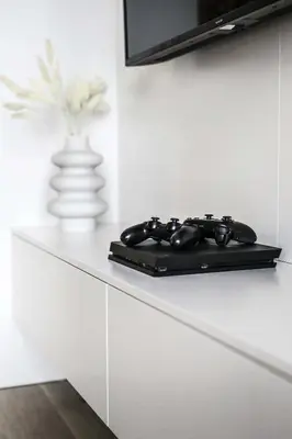 a black remote control sitting on top of a counter at Apartment Premium with Parking, Air Condition and balcony in Kraków