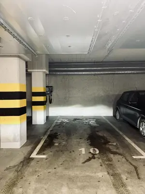a parking garage with a car parked in it at Apartment Premium with Parking, Air Condition and balcony in Kraków