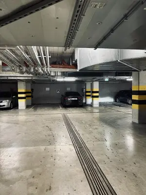 a parking garage with two cars parked in it at Apartment Premium with Parking, Air Condition and balcony in Kraków