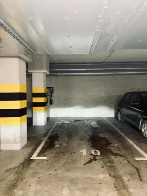 a parking garage with a car parked in it at Apartment Premium with Parking, Air Condition and balcony in Kraków