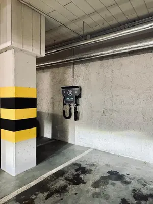 an empty parking garage with a camera on a wall at Apartment Premium with Parking, Air Condition and balcony in Kraków
