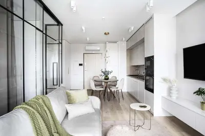 a living room with a white couch and a table at Apartment Premium with Parking, Air Condition and balcony in Kraków