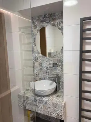 a bathroom with a sink and a mirror at Apartament na Słonecznej in Łączany