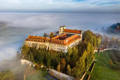 a castle on top of a hill in the clouds at Apartament na Słonecznej in Łączany