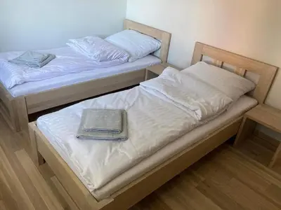 two beds with a book on top of them at Apartament na Słonecznej in Łączany
