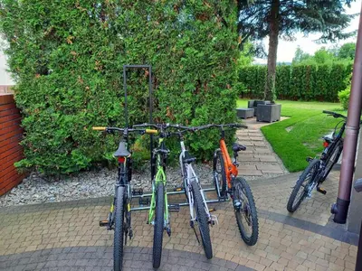 three bikes parked next to each other on a sidewalk at Apartament na Słonecznej in Łączany