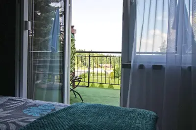 a room with a window with a view of a patio at Motel Na Zbójeckiej in Skawa