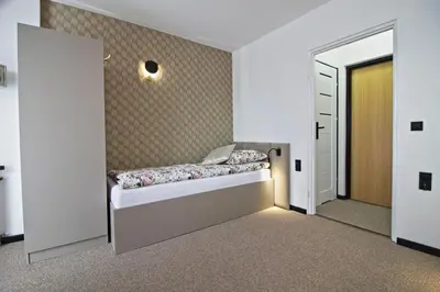 a room with a bed in a room with a door at Motel Na Zbójeckiej in Skawa