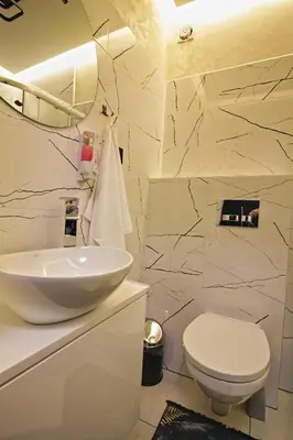 a bathroom with a white sink and a toilet at Motel Na Zbójeckiej in Skawa