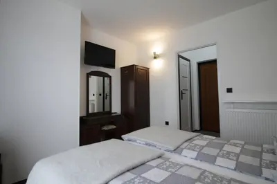 a bedroom with two beds and a mirror at Motel Na Zbójeckiej in Skawa