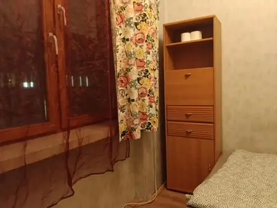 a bedroom with a dresser and a window with a curtain at Time for Cracow in Kraków