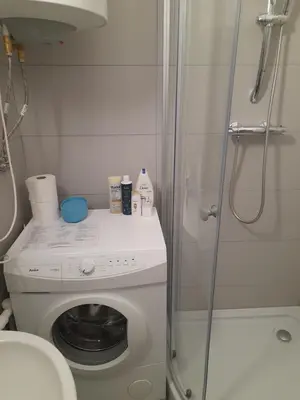 a bathroom with a washing machine and a shower at Time for Cracow in Kraków