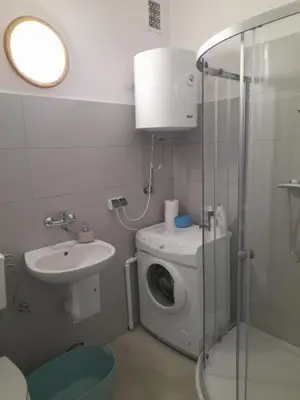 a bathroom with a washing machine and a sink at Time for Cracow in Kraków
