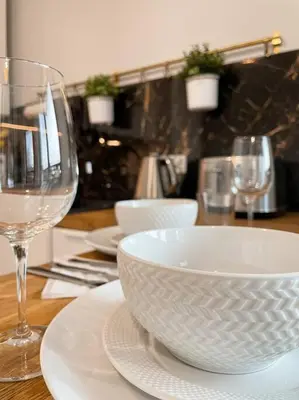 a table with a bowl and a glass of wine at New One Bedroom Apartment with balcony in Kraków